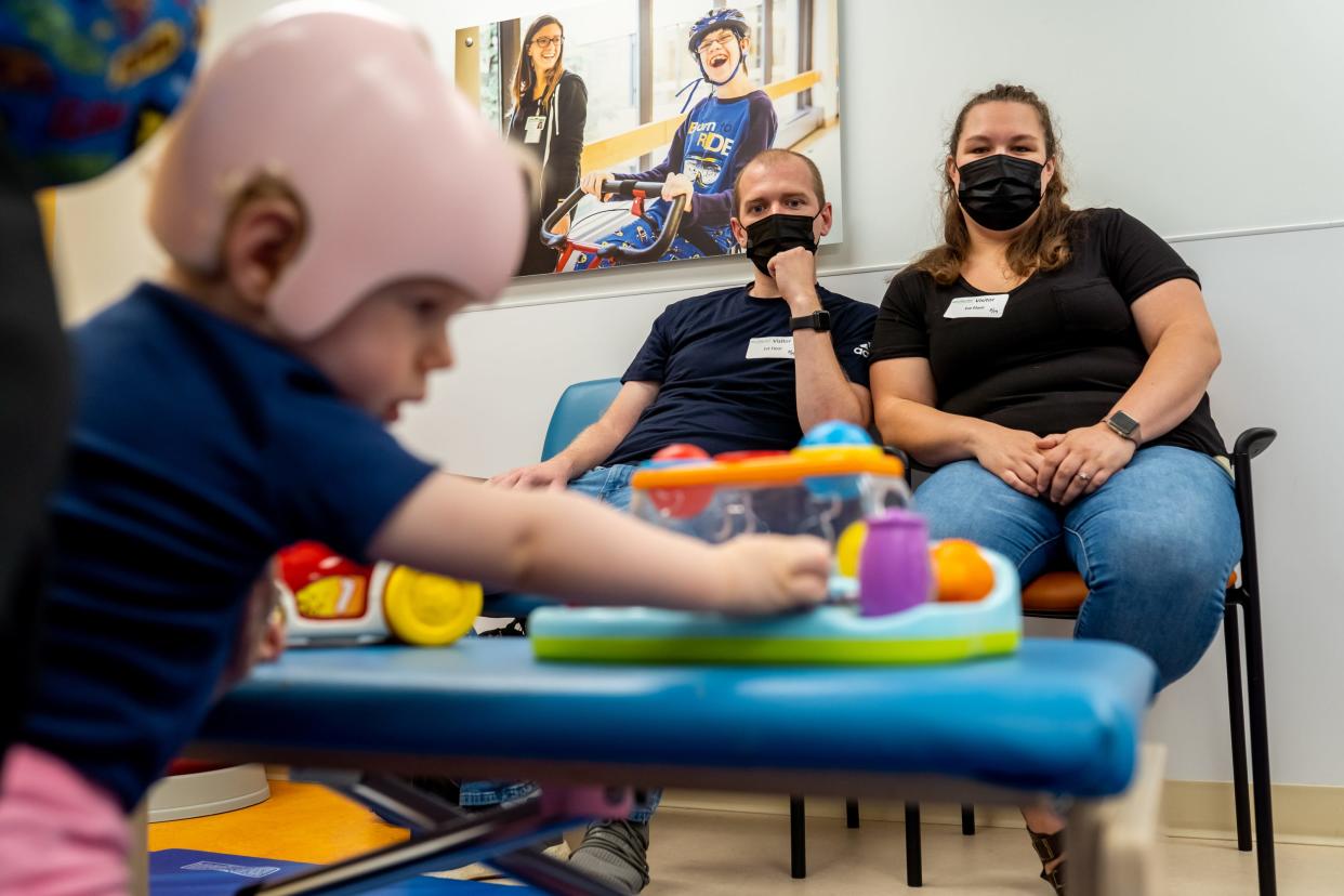 Madelynn Birchmeier works with Physical Therapist Jenae Swiercz at Mary Free Bed Rehabilitation Hospital in Grand Rapids, Michigan, as her parents, Nicole and Adam Birchmeier watch. At more than a year old, she's unable to crawl, walk, stand or even hold her body up while sitting after suffering long-haul COVID-19.