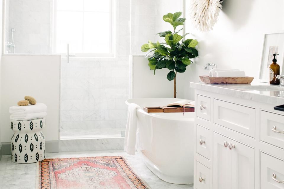 white themed bathroom bathtub standing shower