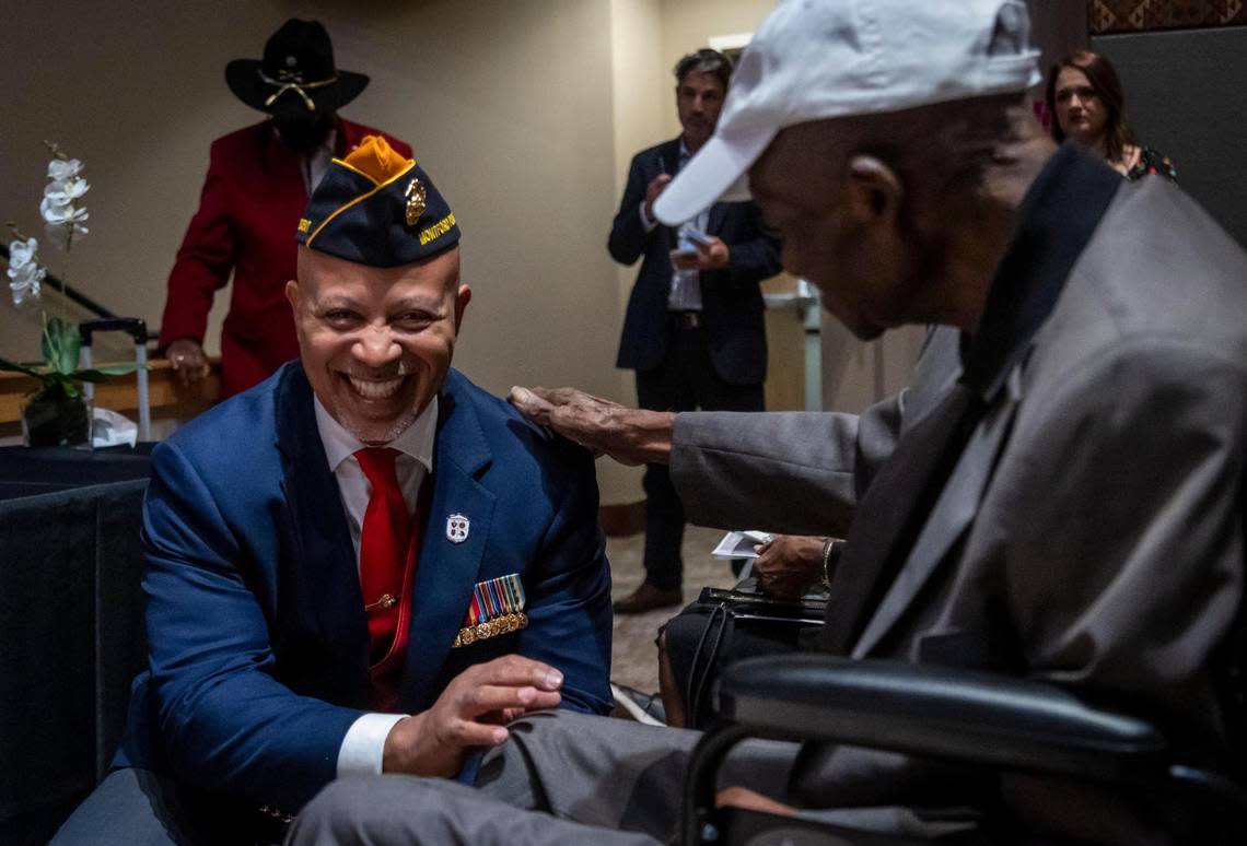 Ronald Johnson, vice president of the Montford Point Marine Association, talks with George J. Johnson, a 101-year-old former Marine honored Monday, Feb. 6, 2023, for being among the first Black recruits allowed to enlist in the United States Marine Corps in the early 1940s.