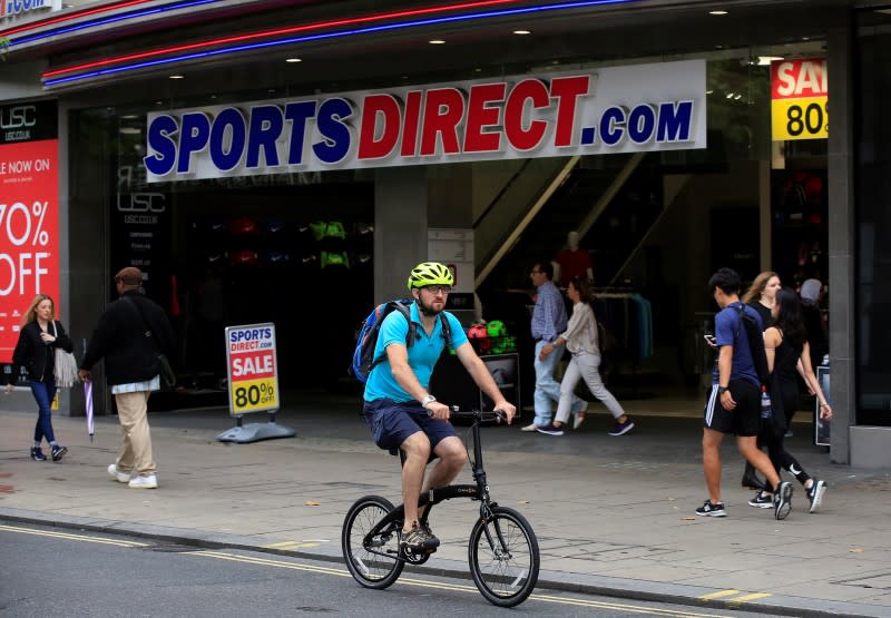 A man cycles past a Sports Direct store on Oxford Street in London July 22, 2016. REUTERS/Paul Hackett