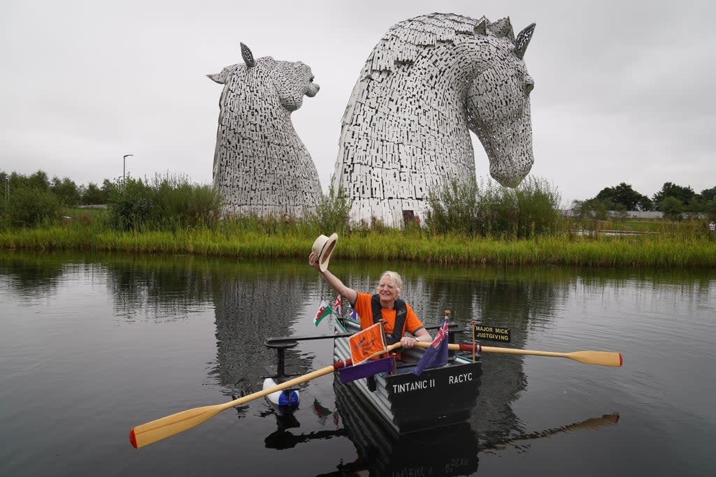 Michael Stanley rows his boat Tintanic II along the Forth and Clyde Canal past the Kelpies (Andrew Milligan/PA) (PA Wire)