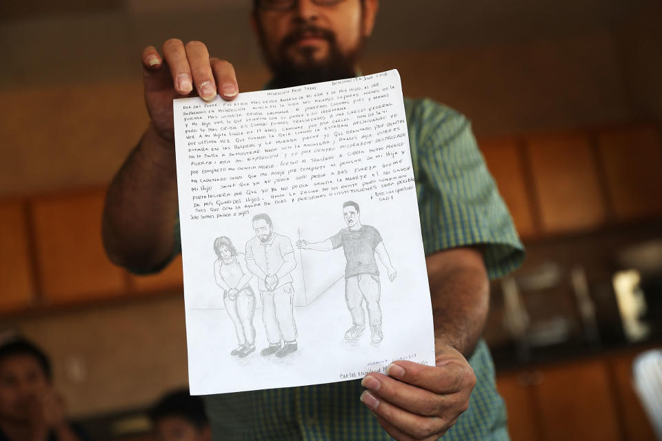 A man identified only as Carlos shows off a drawing he made when his son, Esli (depicted in the right of the drawing) was taken from him on July 25, 2018, in El Paso, Texas