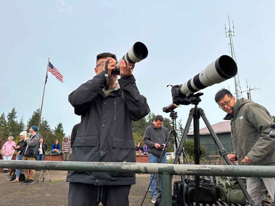 John Li, left, and Dax Li set up to make photos of the annular eclipse from the top of Skinner Butte in Eugene on Saturday morning.