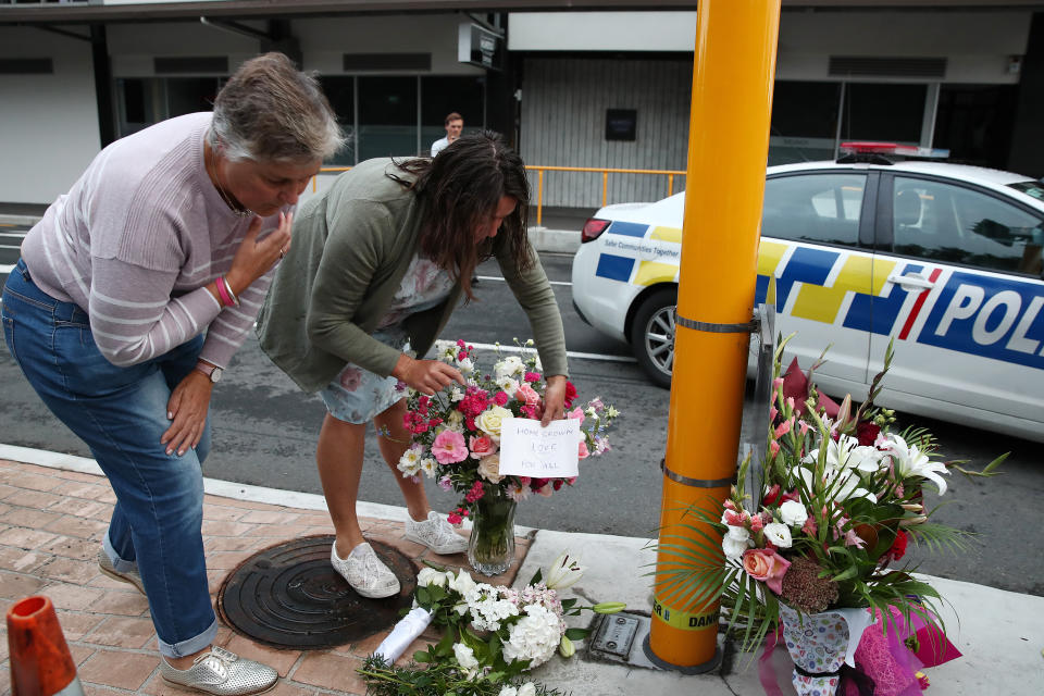 Local residents leave floral tributes at Deans Avenue near the Al Noor Mosque in Christchurch, New Zealand.