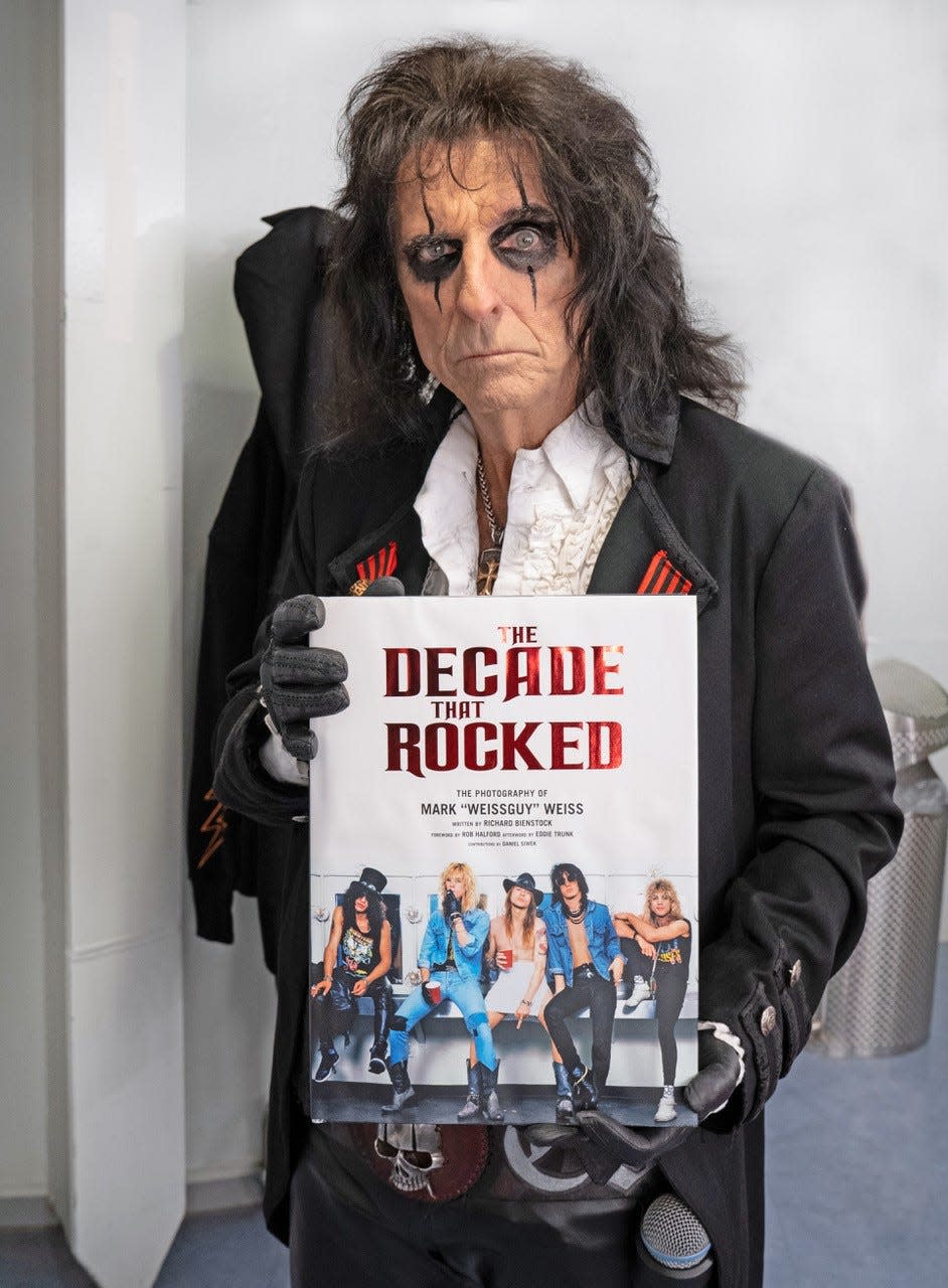 Alice Cooper holding "The Decade That Rocked" by photographer Mark Weiss.