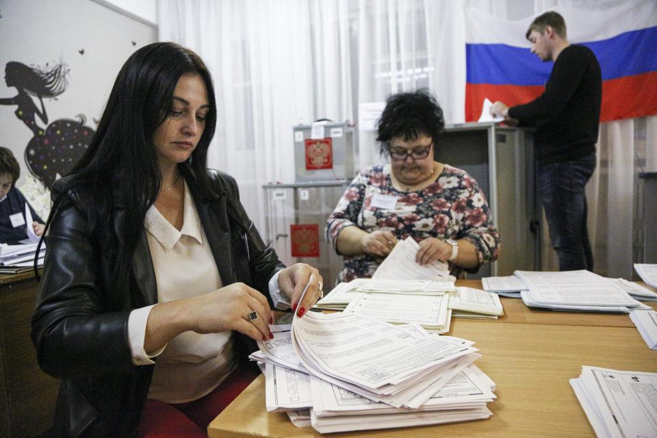 Members of an election commission count ballots after voting at a polling station after the Parliamentary elections in Nikolayevka village outside Omsk, Russia, Sunday, Sept. 19, 2021. From the Baltic Sea to the Pacific Ocean, Russians across eleven time zones voted Sunday on the third and final day of a national election for a new parliament, a ballot in which the pro-Kremlin ruling party is largely expected to retain its majority after months of relentless crackdown on the opposition. (AP Photo/Evgeniy Sofiychuk)