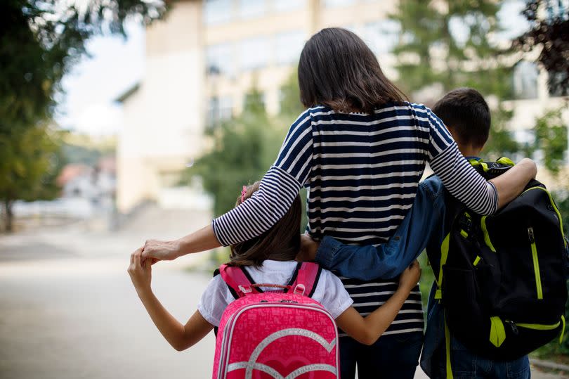 Parent taking children to school