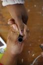 A voter has her finger marked to prove that she has voted at a polling station in the township of Nyanga on the outskirts of Cape Town, South Africa, Wednesday, May 7, 2014. (AP Photo/Schalk van Zuydam)