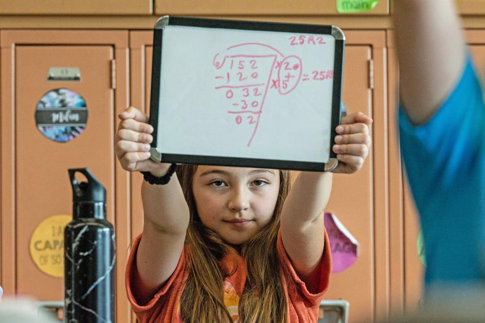 A fourth grade student of Wilbur Elementary School solves a math problem in a classroom in Bear, Thursday, May 18, 2023. The children shared their experience about a recent visit to legislative hall where they testified and shared their research on second hand smoke, in support of a bill that will prohibit smoking in cars with children under 18.