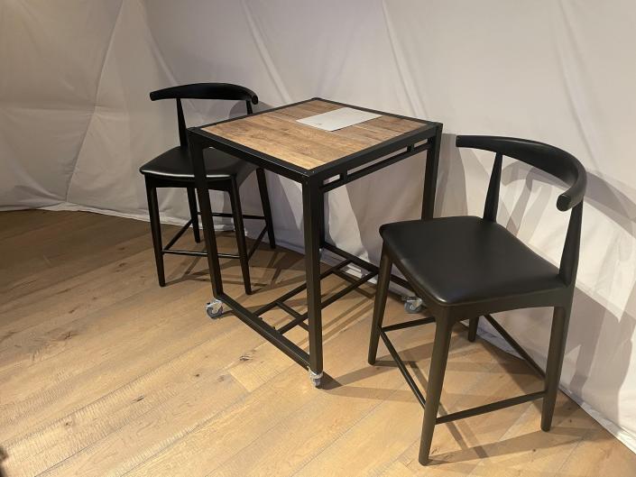 A small table and two chairs were stationed near the kitchen.