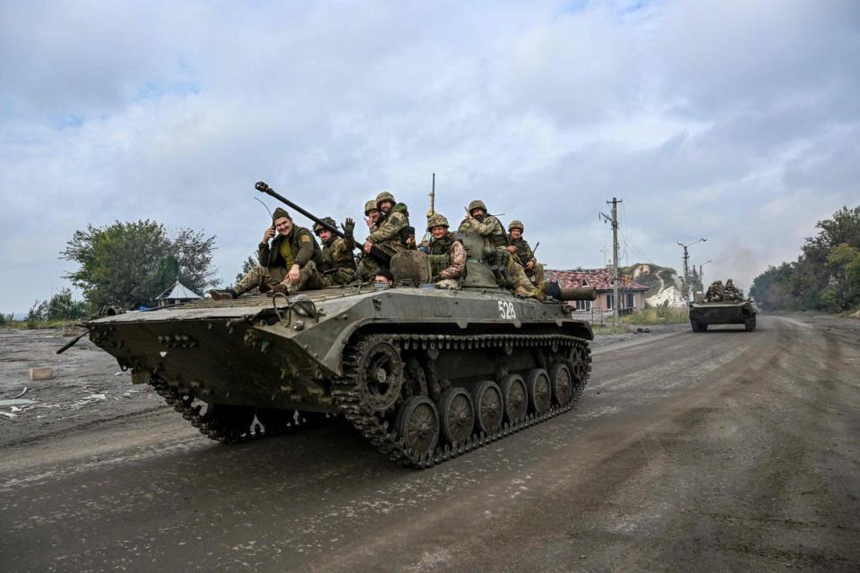 Ukrainian soldiers sit on infantry fighting vehicles as they drive near Izyum, eastern Ukraine (AFP via Getty Images)