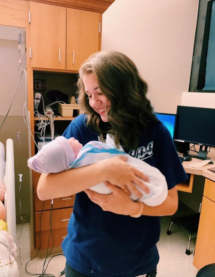 Kaylee Snider, Lydia Brown's friend who helped convince her not to get an abortion when she first found out she was pregnant, holds Atlas soon after he was born in August of 2019.