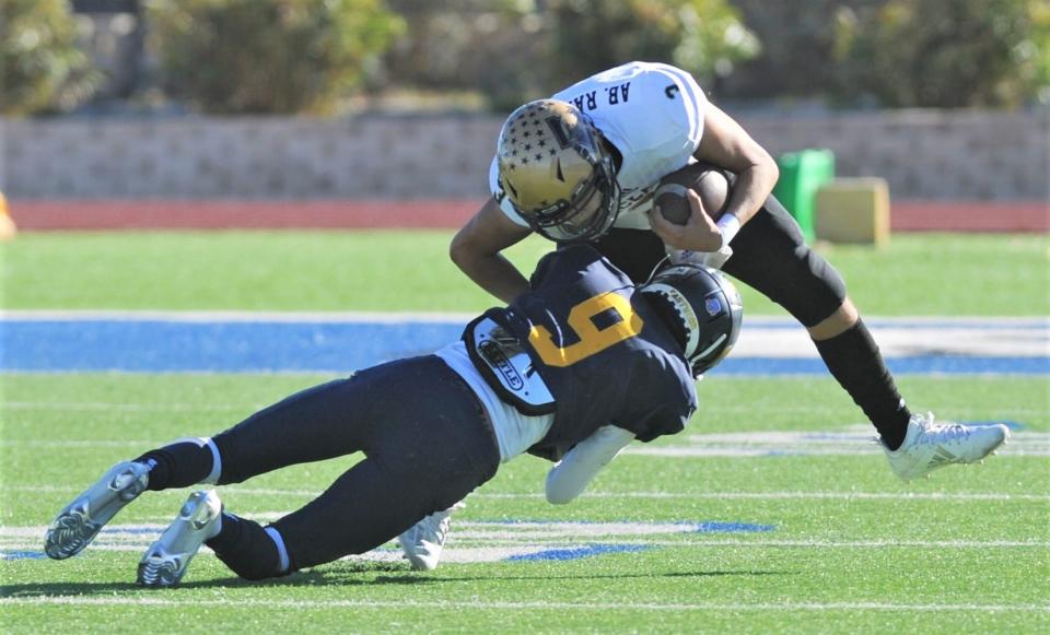 El Paso Eastwood's Curtis Murillo (9) upends Abilene High quarterback Abel Ramirez. Abilene High won the Region I-6A Division II bi-district playoff game Saturday, Dec. 12, 2020, at Panther Stadium in Fort Stockton.