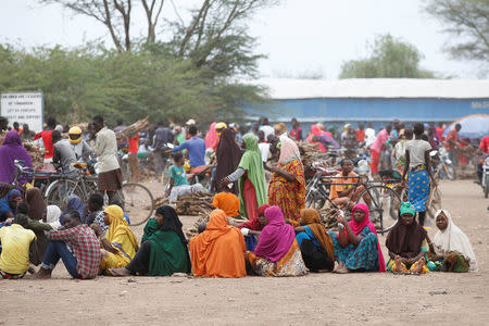 Women wait in line to receive aid at the Kakuma refugee camp in northern Kenya, March 6, 2018. REUTERS/Baz Ratner