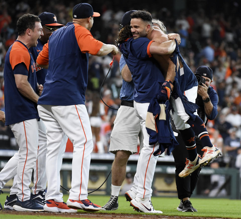 Houston Astros' Jose Altuve, right, celebrates his game-winning three-run home run with Lance McCullers Jr., second from right, and teammates during the ninth inning of a baseball game against the New York Yankees, Sunday, July 11, 2021, in Houston. (AP Photo/Eric Christian Smith)