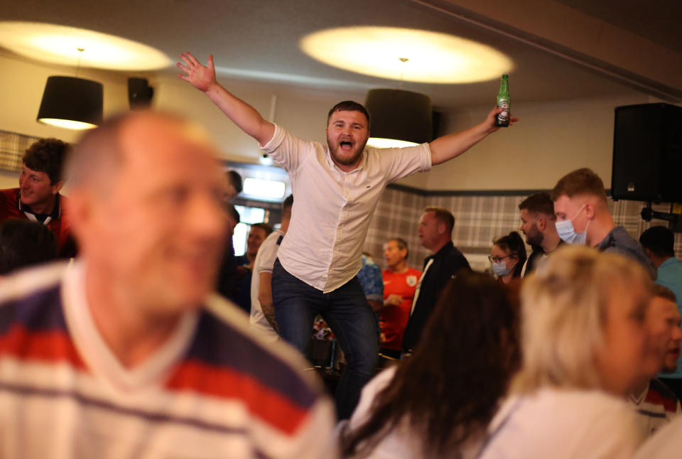 Soccer Football - Euro 2020 - Fans gather ahead of Ukraine v England - The Thistleberry pub, Newcastle-under-Lyme, Britain - July 3, 2021 England fans celebrate scoring a goal Action Images via Reuters/Carl Recine