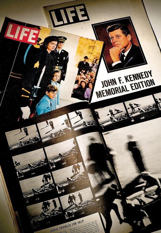 The assassination of President John F. Kennedy was depicted in the pages of the Nov. 29, 1963, edition of Life magazine with a frame-by-frame sequence of the Zapruder film. Also in the photo is the Dec. 6, 1963, edition featuring first lady Jacqueline Kennedy and her daughter, Caroline, and son, John Jr., at the funeral procession in Washington, D.C., and the special JFK Memorial Edition.