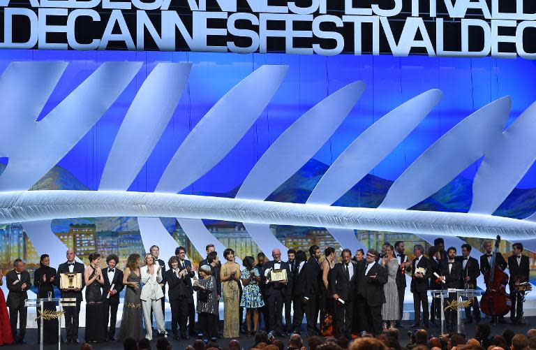 French director Jacques Audiard (C) poses on stage with Feature Film jury members after being awarded with the Palme d'Or for his film "Dheepan" during the closing ceremony of the 68th Cannes Film Festival in Cannes, France, on May 24, 2015