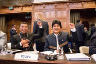 Bolivian President Evo Morales (R) gestures as he arrives for the opening of hearings at the World Court in The Hague, Netherlands March 19, 2018. REUTERS/David Morales