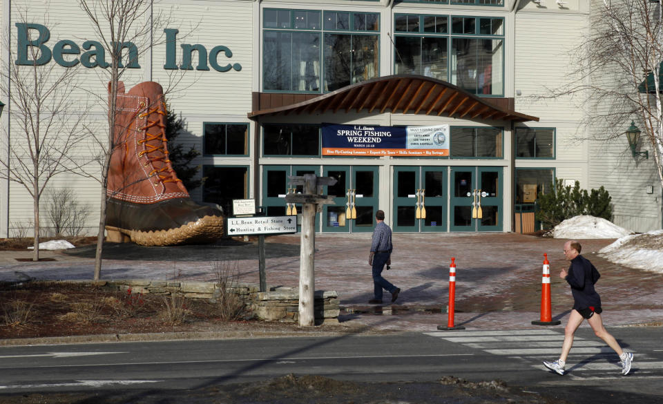 FILE - In this March 8, 2012 file photo, a jogger passes by the entrance to the L.L. Bean retail store in Freeport, Maine. L.L. Bean says sales grew 5.5 percent over the past year despite a mild winter weather that hurt sales of skis, coats and other outdoor gear for which the company is known. (AP Photo/Robert F. Bukaty, File)
