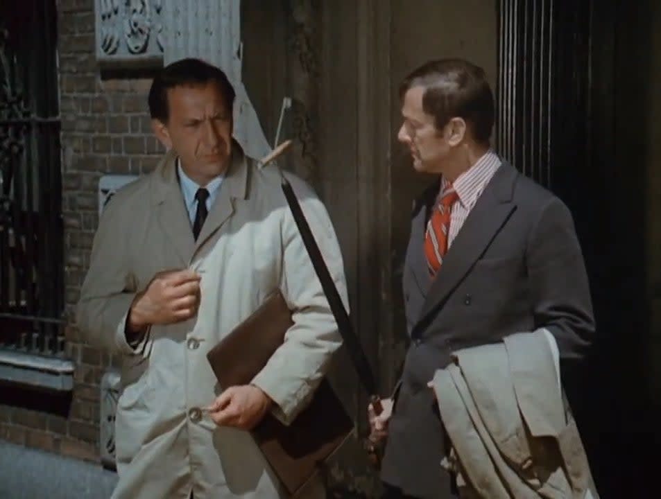 Felix holding up a cigarette on an umbrella in front of Oscar in the intro to "The Odd Couple"