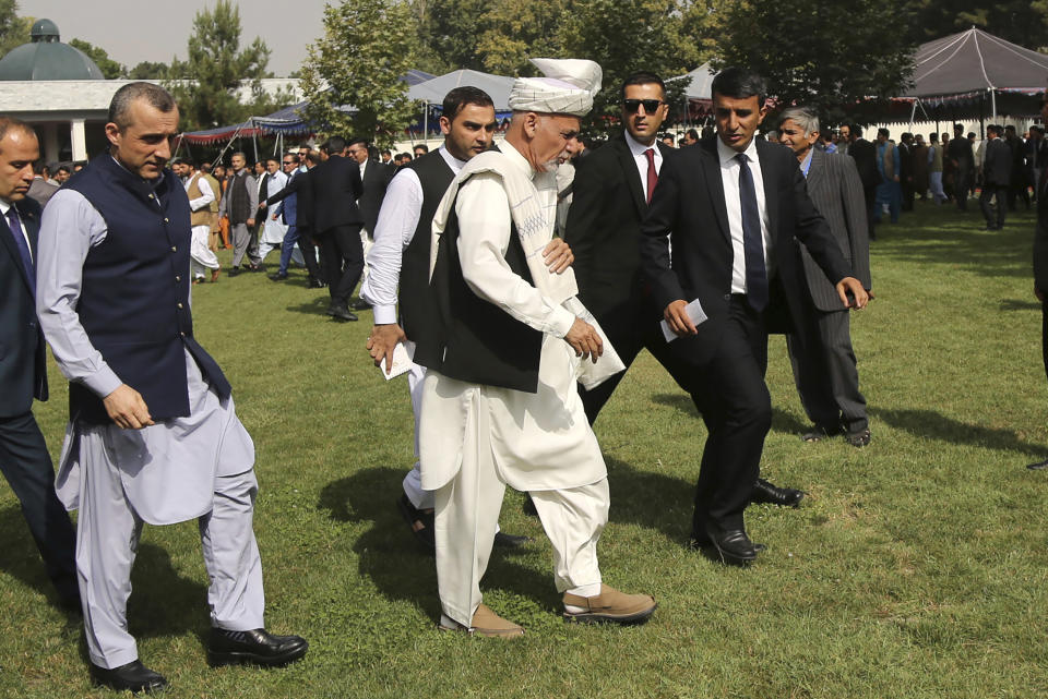 Afghanistan's President Ashraf Ghani, center, arrives for a speech after offering Eid al-Adha prayers at the presidential palace in Kabul, Afghanistan, Sunday, Aug. 11, 2019. Ghani is urging the nation to determine its fate without foreign interference as the United States and the Taliban appear to near a peace deal without the Afghan government at the table.(AP Photo/Nishanuddin Khan)