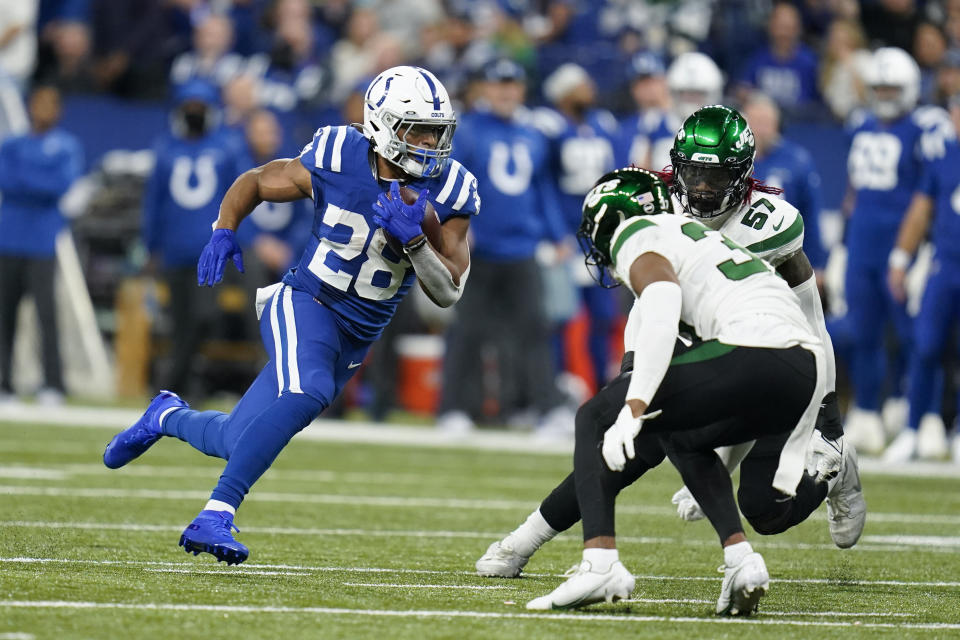 Indianapolis Colts' Jonathan Taylor (28) runs against New York Jets' Bryce Hall (37) during the first half of an NFL football game, Thursday, Nov. 4, 2021, in Indianapolis. (AP Photo/Michael Conroy)