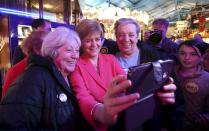 First Minister for Scotland Nicola Sturgeon takes a selfie with supporters during a campaign visit to a theme Park, Motherwell, central Scotland, May 3, 2015. REUTERS/Paul Hackett