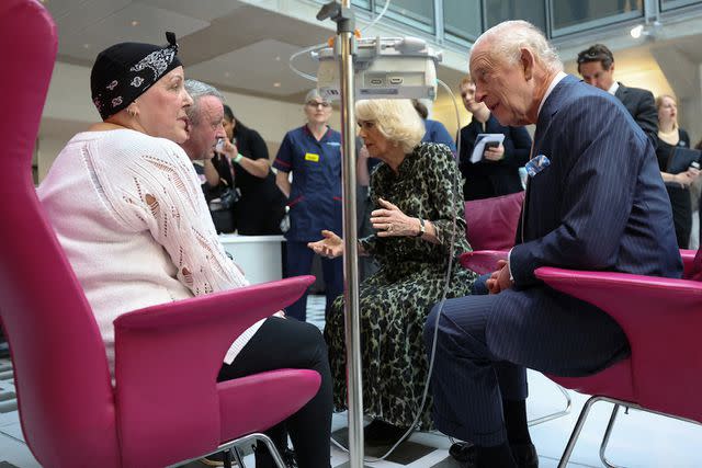<p>SUZANNE PLUNKETT/POOL/AFP via Getty Images</p> Queen Camilla (center) and King Charles (right) visit University College Hospital Macmillan Cancer Centre in London on April 30, 2024