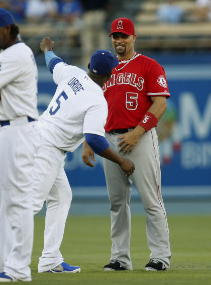 Albert Pujols (right) and Juan Uribe speak before the opener of the Freeway Series. (AP)