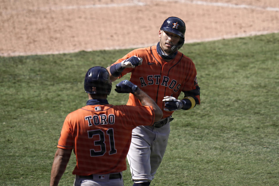 Houston Astros' Carlos Correa, right, celebrates his home run with Abraham Toro during the seventh inning of a baseball game against the Los Angeles Angels, Sunday, Sept. 6, 2020, in Anaheim, Calif. (AP Photo/Jae C. Hong)