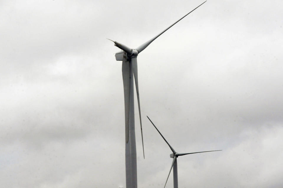 A broken blade is seen on a 300-foot wind turbine Tuesday, April 29, 2014, south of Highmore, S.D., where single-engine Piper crashed in foggy weather Sunday evening April 27, 2014, killing the pilot and three cattlemen. A National Transportation Safety Board investigator is trying to determine why the airplane was flying so low when it apparently hit the blade of the wind turbine. The wreckage of the plane will be removed by Wednesday from the site and taken to Colorado. (AP Photo/Capital Journal, Joel Ebert)