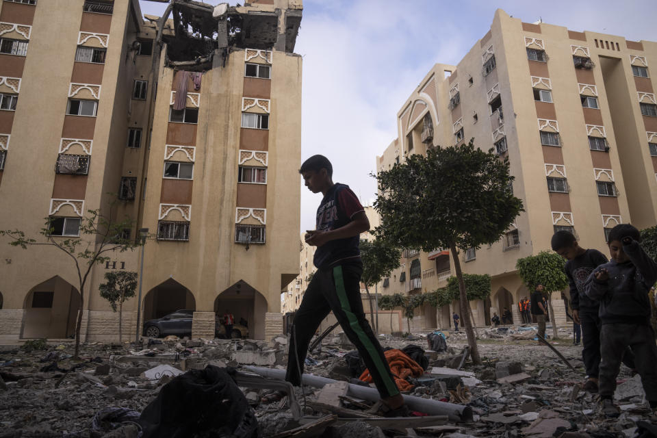 Palestinians inspect the rubble of the home of Ali Ghali, a senior Islamic Jihad commander, after it was struck by an Israeli airstrike in Khan Younis, southern Gaza Strip, Thursday, May 11, 2023. Early on Thursday, the Israeli military killed Ghali, said to be in charge of the group's rocket force, when it struck his home as part of strikes against the Islamic Jihad militant group. (AP Photo/Fatima Shbair)