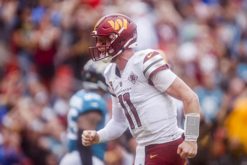 Washington Commanders quarterback Carson Wentz (11) celebrates his second touchdown pass during the first half of a NFL football game between the Washington Commanders and the Jacksonville Jaguars on Sunday, Sept. 11, 2022 at FedExField in Landover, Md. (Shaban Athuman/Richmond Times-Dispatch via AP)