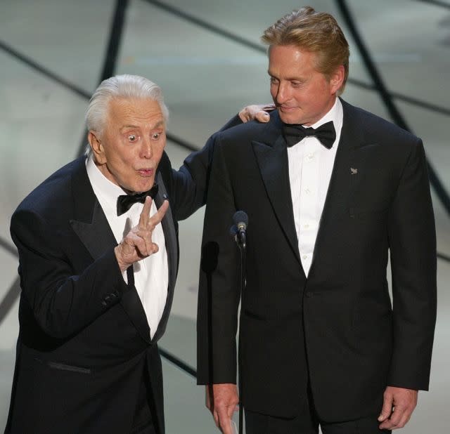 Kirk Douglas accompanied by his son Michael Douglas on stage at the Kodak Theatre at the 75th Oscars in 2003