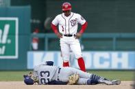 Apr 28, 2019; Washington, DC, USA; San Diego Padres shortstop Fernando Tatis Jr. (23) lies on the ground after being injured while attempting a force out on Washington Nationals shortstop Wilmer Difo (1) at second base in the tenth inning at Nationals Park. The Nationals won 7-6 in eleven innings. Mandatory Credit: Geoff Burke-USA TODAY Sports
