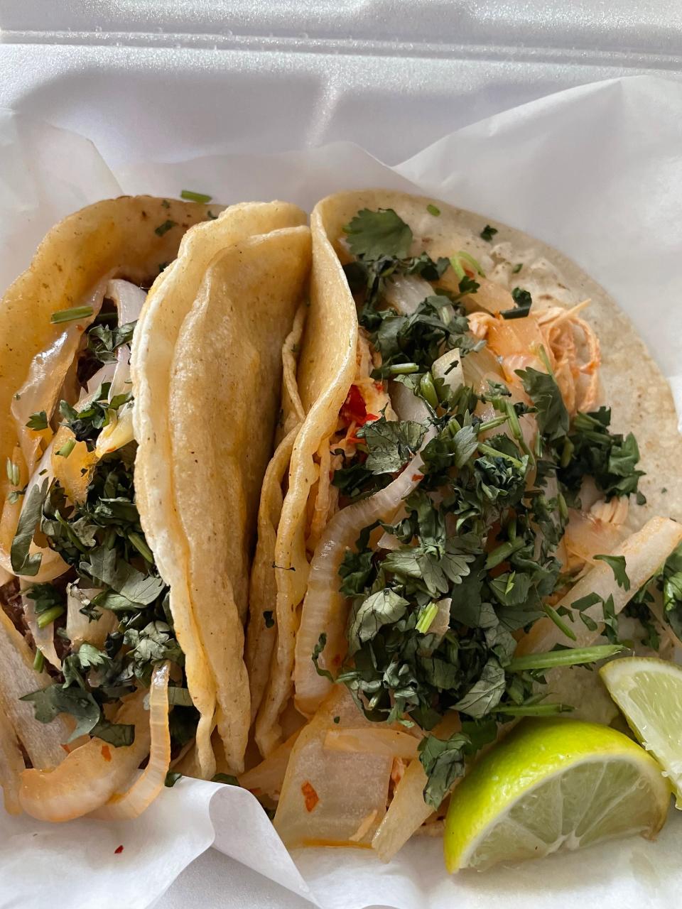 Chilakil showers its tacos with onion and cilantro.