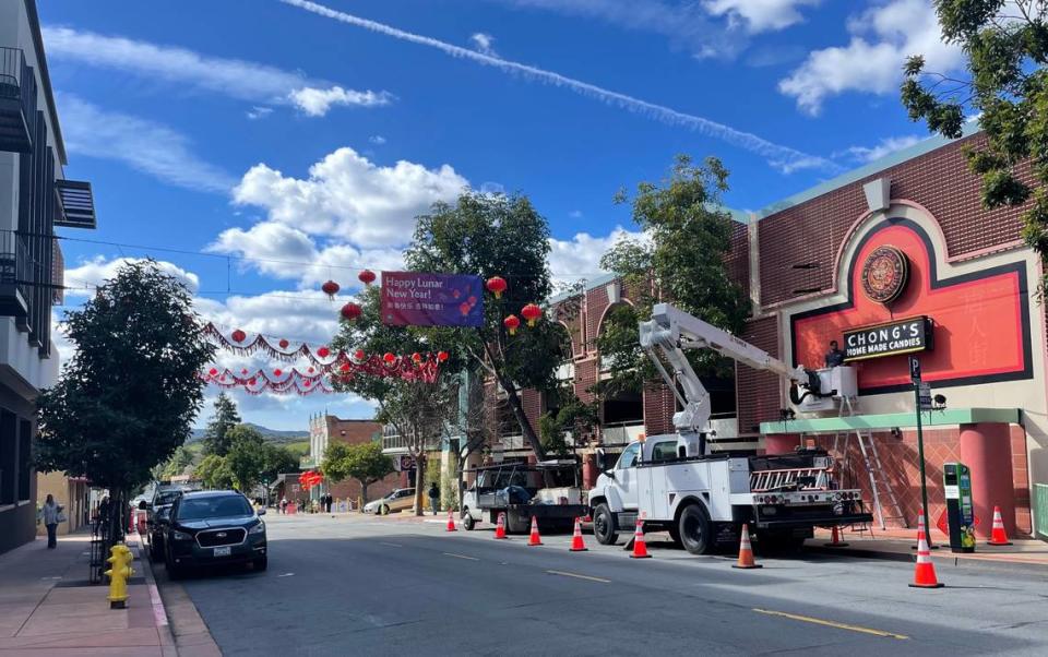 Workers install a neon sign in downtown San Luis Obispo’s Historic Chinatown District ahead of a Lunar New Year block party on Feb. 9, 2024. 