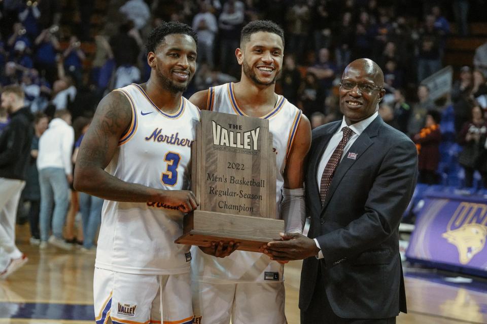 Tywhon Pickford, Trae Berhow and Missouri Valley Conference commissioner Jeff Jackson pose with the regular-season championship trophy after the Panthers beat Loyola Saturday in Cedar Falls.