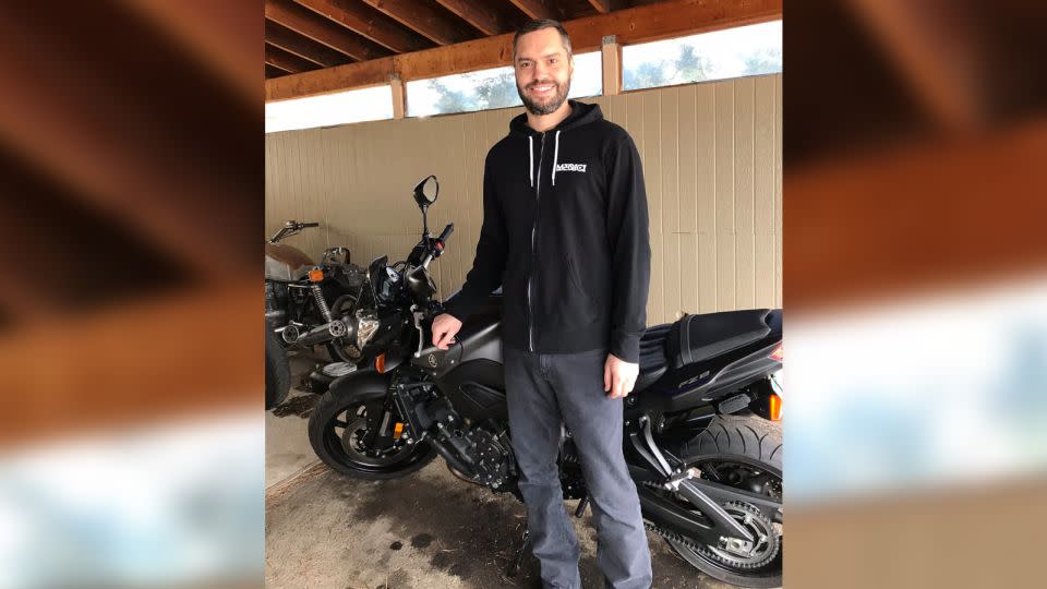 Shawn smiles near a motorcycle in February 2018. - Alexandra Wyman