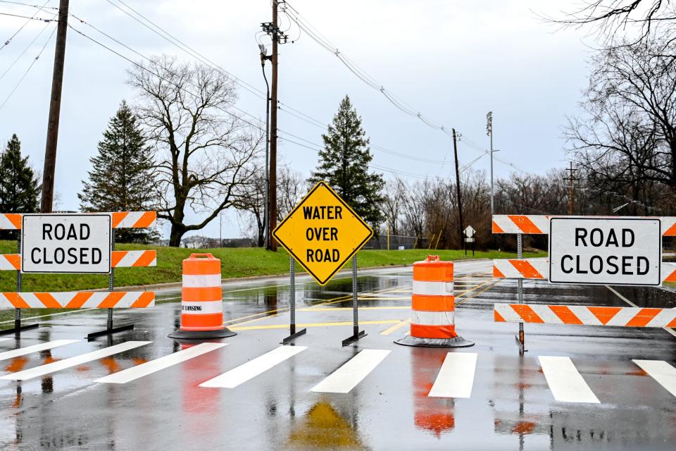 Kalamazoo Street is blocked near Clippert Street due to flooding after a storm on Wednesday, April 5, 2023, in Lansing.