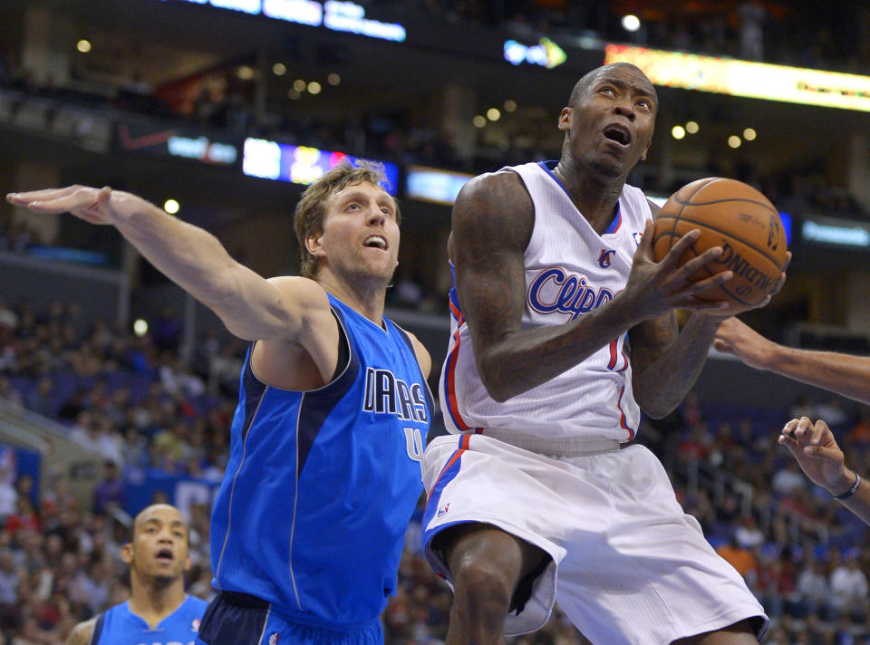 Los Angeles Clippers guard Jamal Crawford, right, puts up a shot as Dallas Mavericks forward Dirk Nowitzki, of Germany, defends during the first half of an NBA basketball game, Wednesday, Jan. 15, 2014, in Los Angeles. (AP Photo/Mark J. Terrill)