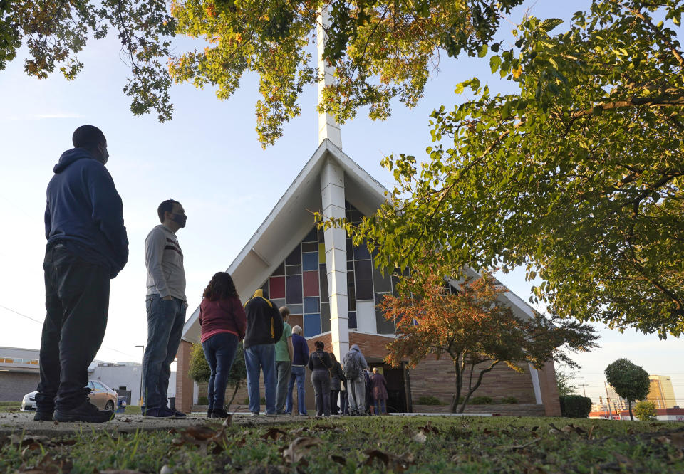 FILE - In this Tuesday, Nov. 3, 2020 file photo, Voters line up outside Vickery Baptist Church waiting to cast their ballots on Election Day in Dallas. In Georgia, faith leaders are asking corporate executives to condemn laws restricting voting access — or face a boycott. In Arizona and Texas, clergy have assembled outside the state capitols to decry what they view as voter-suppression measures targeting Black and Hispanic people. (AP Photo/LM Otero, File)