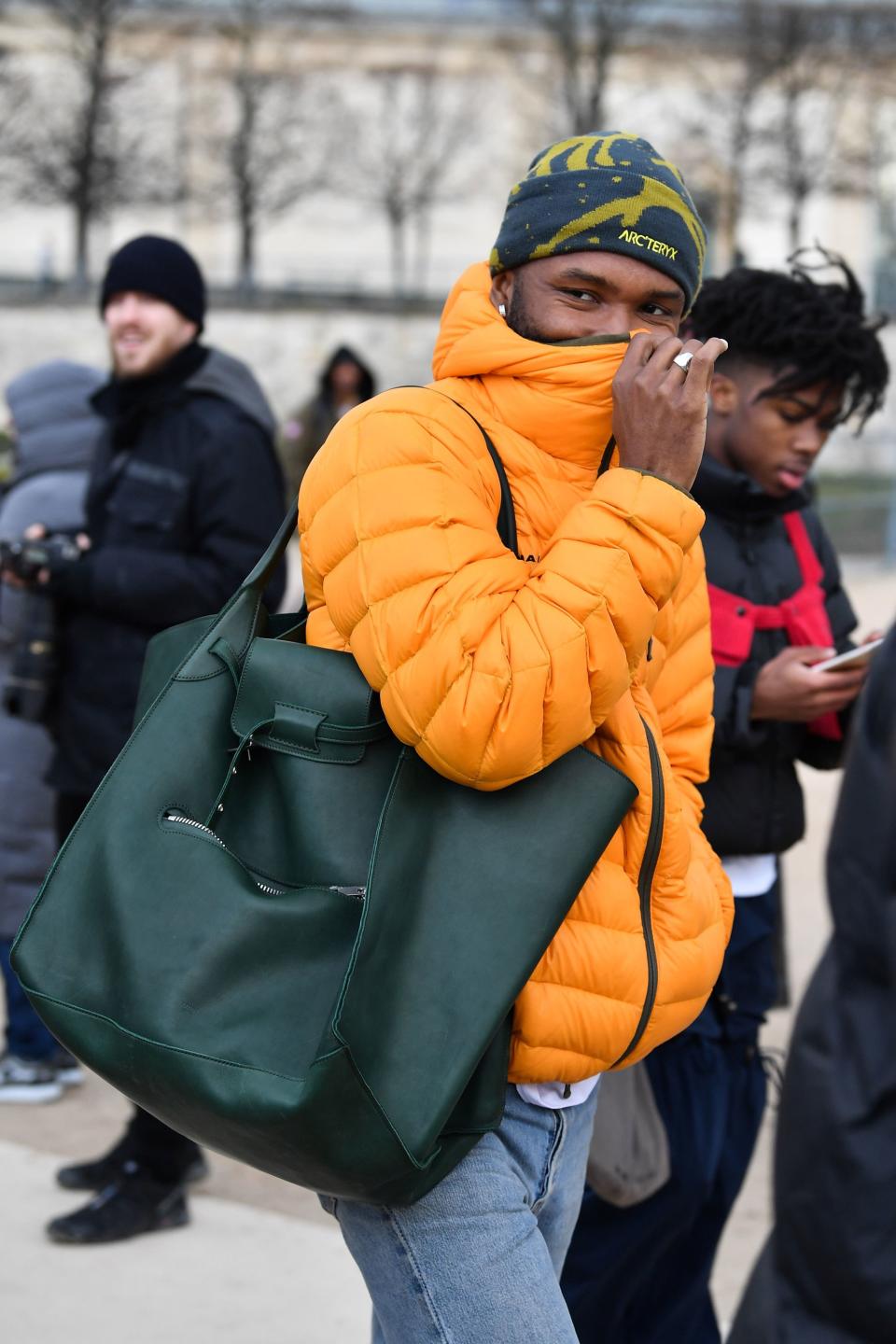 He paired the oversize bag with a vibrant puffer and a printed beanie.