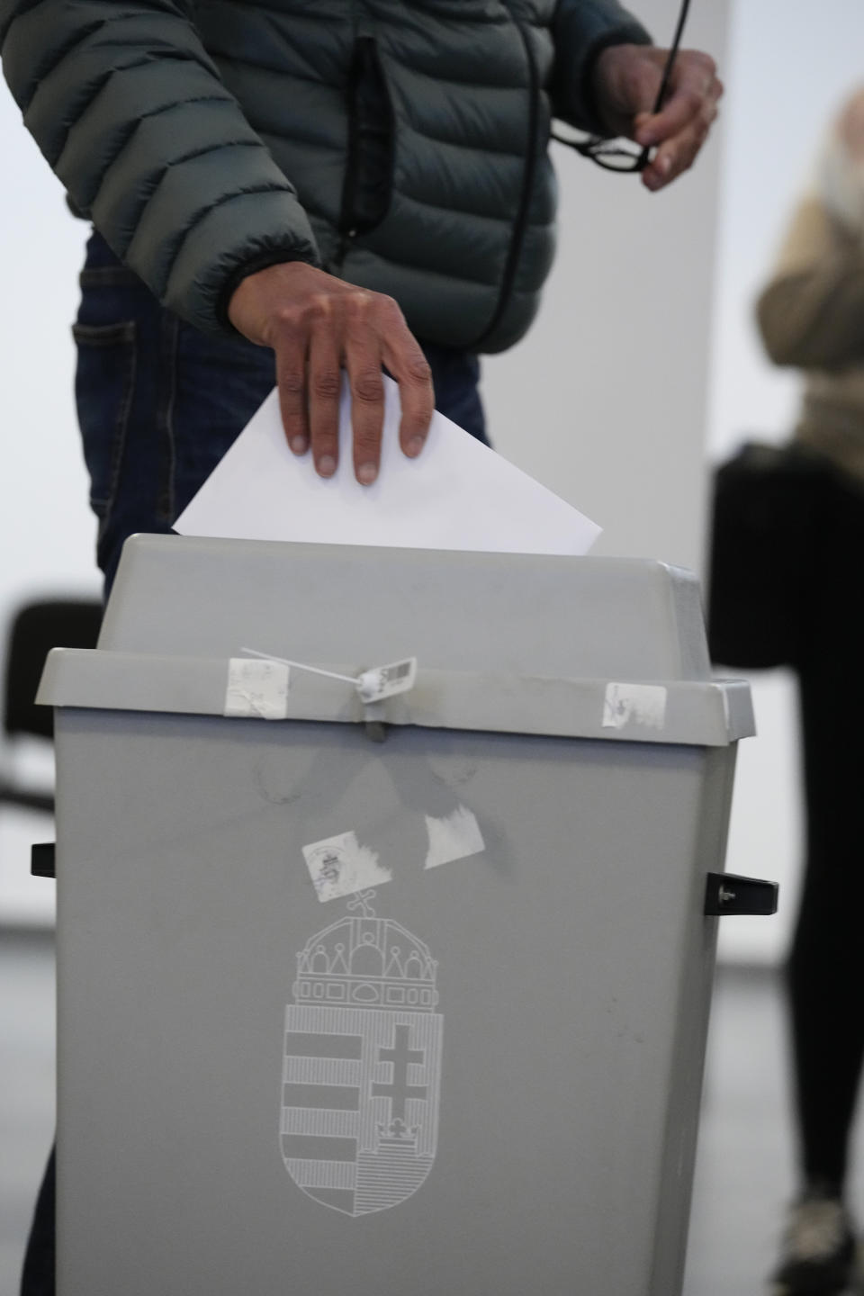 A person casts his ballot in Budapest, Hungary, Sunday, April 3, 2022. Hungary's nationalist prime minister, Viktor Orban, seeks a fourth straight term in office, a coalition of opposition parties are framing the election as a referendum on Hungary's future in the West. (AP Photo/Petr David Josek)