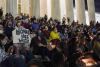 People gather at the Supreme Court Friday, Sept. 18, 2020, in Washington, after the Supreme Court announced that Supreme Court Justice Ruth Bader Ginsburg has died of metastatic pancreatic cancer at age 87. (AP Photo/Alex Brandon)