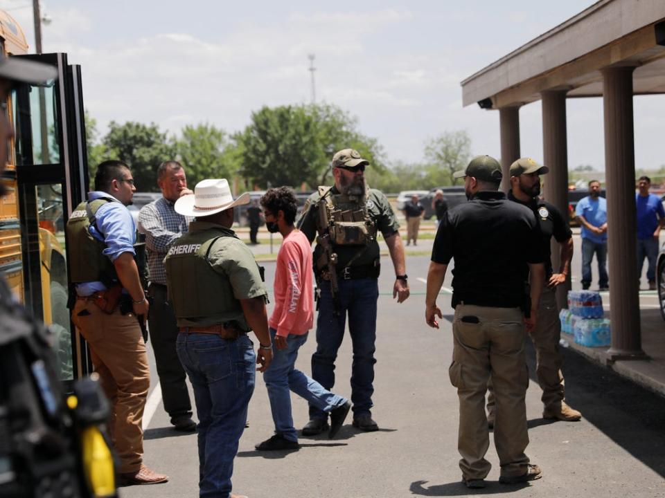 Children get on a school bus as law enforcement personnel guard the scene of a suspected shooting near Robb Elementary School in Uvalde, Texas, U.S. May 24, 2022 (REUTERS)