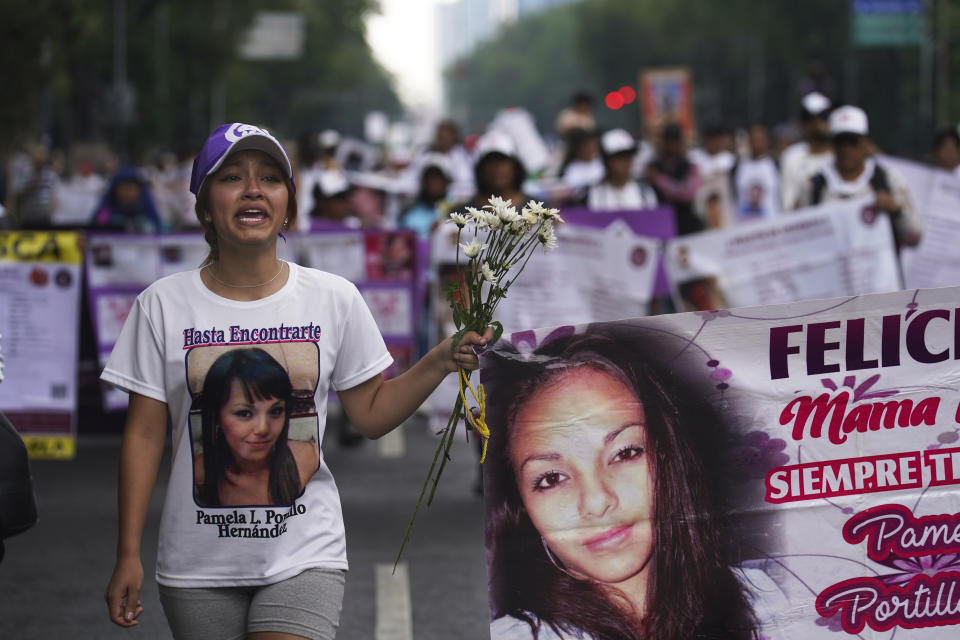 Vania Hernandez Portillo, whose mother is disappeared, joins mothers of disappeared children in a march to demand government help in the search for their missing loved ones, on Mother's Day in Mexico City, Wednesday, May 10, 2023. (AP Photo/Marco Ugarte)
