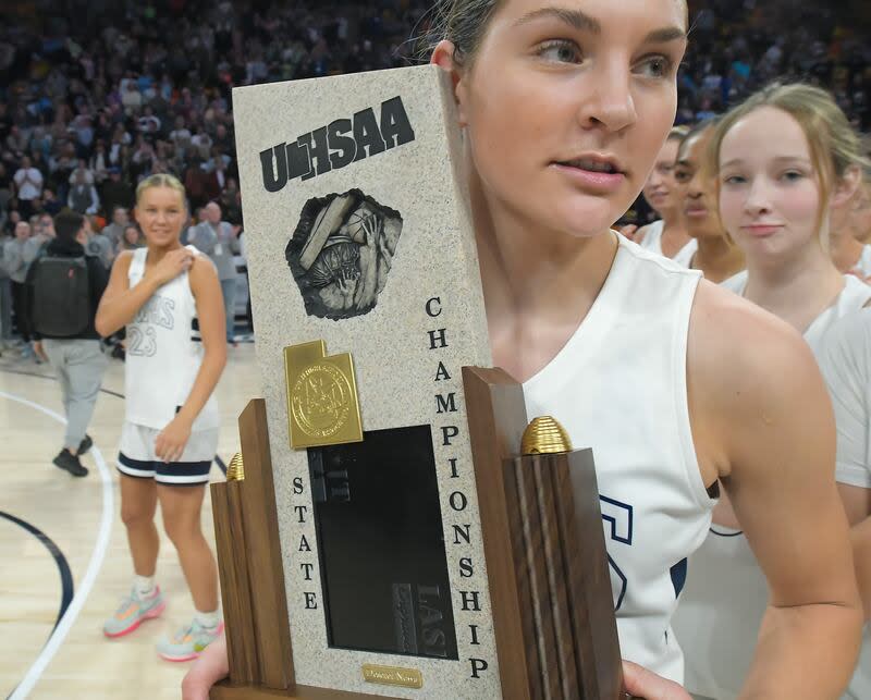 Ridgeline's Emilee Skinner hold the championship trophy after winning the Utah 4A girls basketball tournament on Saturday in Logan. | Eli Lucero, Herald Journal