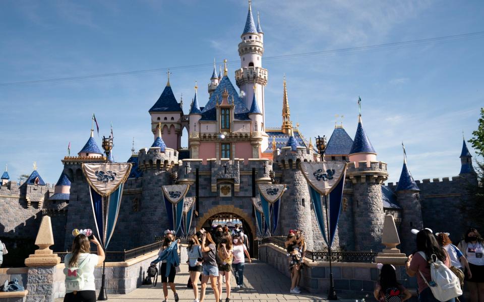 In this Friday, April 30, 2021, file photo, visitors exit The Sleeping Beauty Castle at Disneyland in Anaheim, Calif. California will offer six "dream vacation" incentives to spur more people to get coronavirus vaccinations, California Gov. Gavin Newsom said Monday, June 14, 2021, on the eve of the state's awarding of $15 million in cash prizes.  - AP